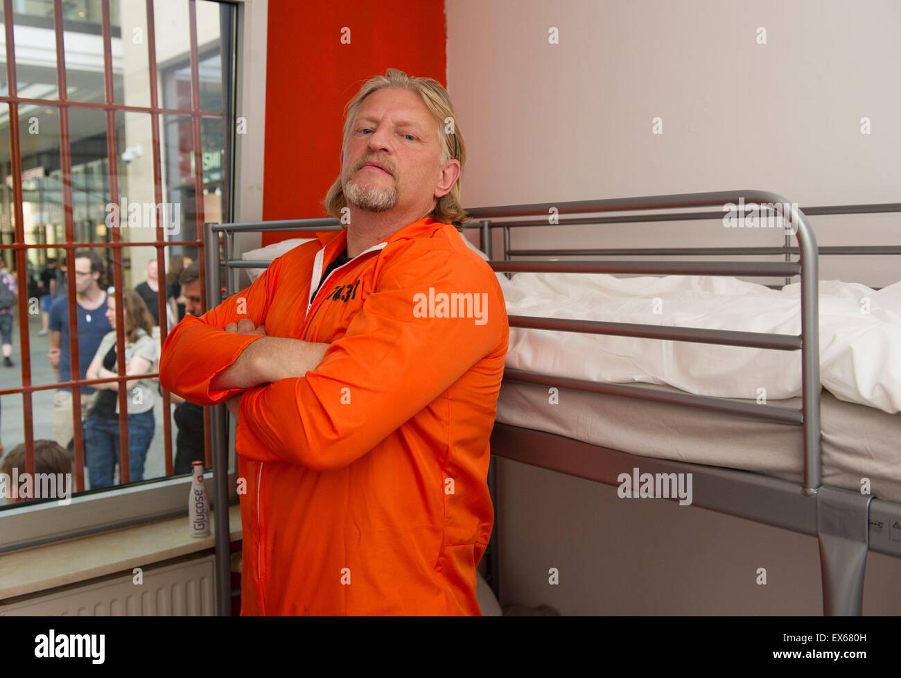 Berlin, Germany. 07th July, 2015. German actor Frank Kessler poses in a 'jail container' inside a mall in Berlin, Germany, 07 July 2015. The actor promotes the US series 'Orange Is the New Black' that is broadcasted on Netflix via streaming since 2013 in the US. Photo: Paul Zinken/dpa/Alamy Live News Stock Photo