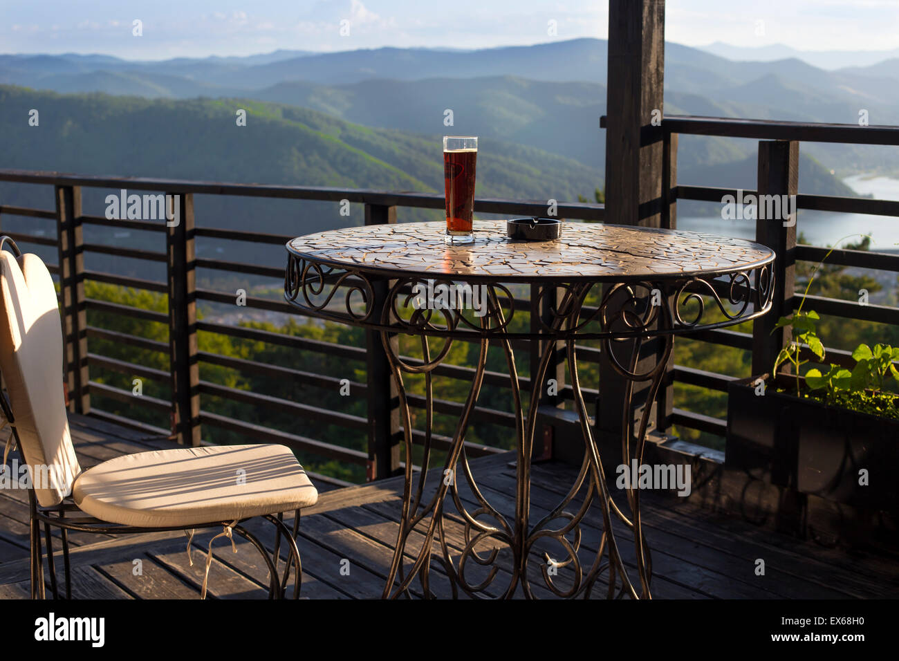 Beer glass on the bar table at the open-air cafe in mountains Stock Photo