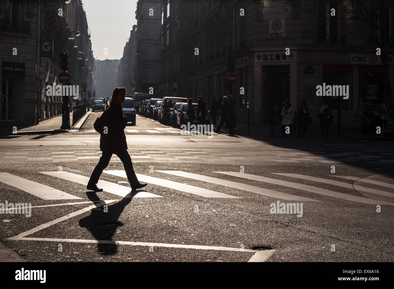 Woman crossing the road at a pedestrian crossing, Paris, France Stock ...