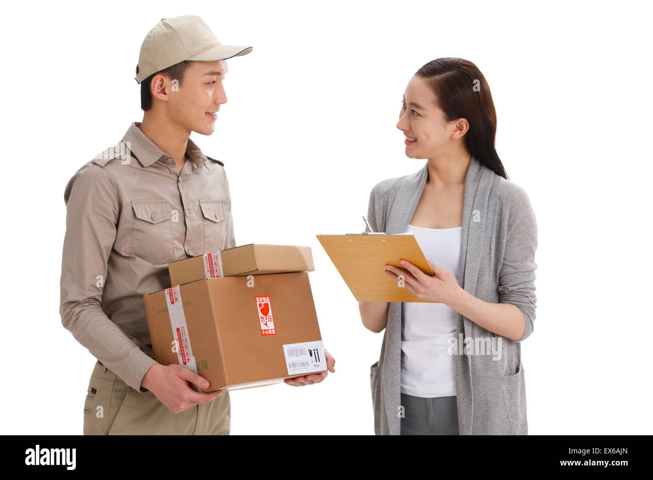 Young delivery man delivering package to customer Stock Photo
