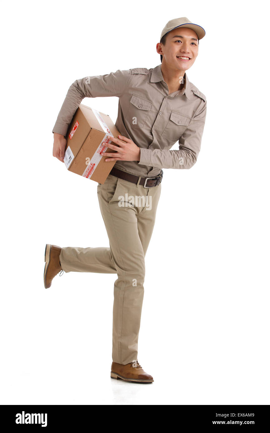 Portrait of young man holding package Stock Photo