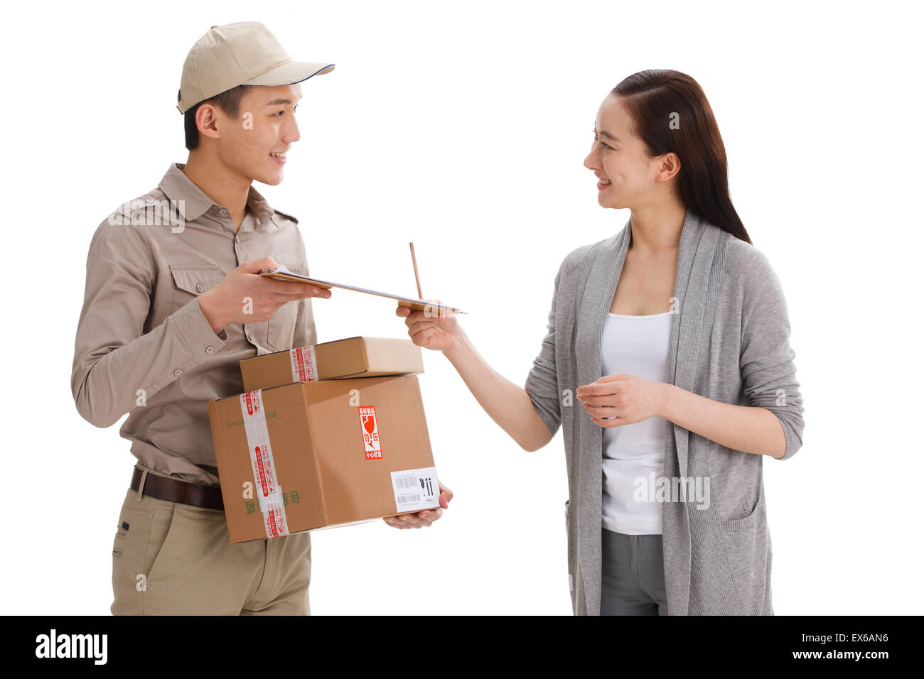 Young delivery man delivering package to customer Stock Photo