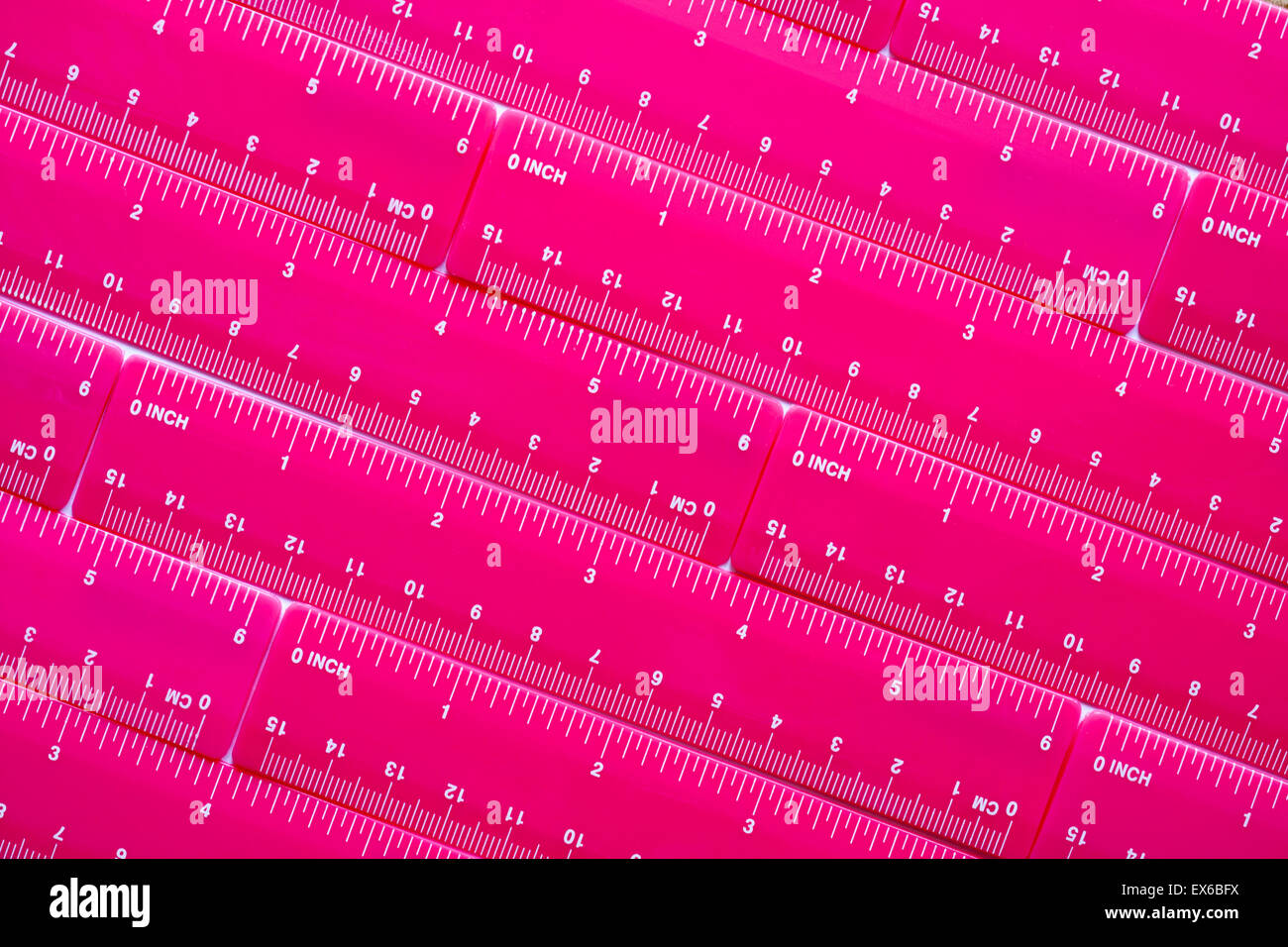 colourful pink rulers plastic diagonally placed Stock Photo