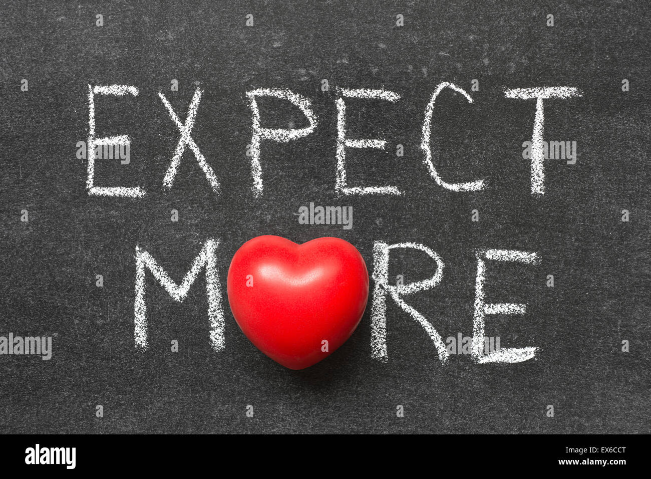 expect more phrase handwritten on blackboard with heart symbol instead of O Stock Photo