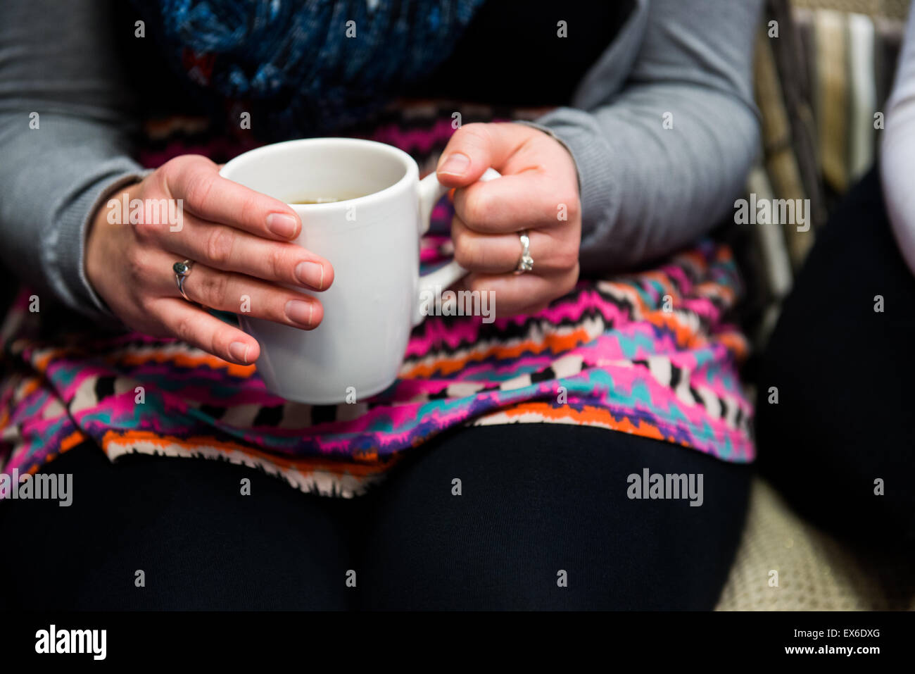 Girl drinking cup of tea and talking Stock Photo