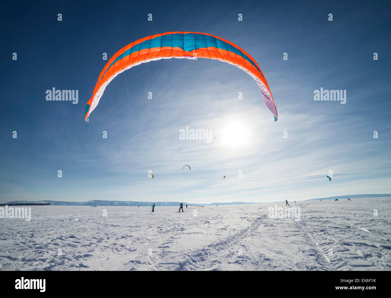 Kiteboarder with blue kite on the snow Stock Photo Alamy