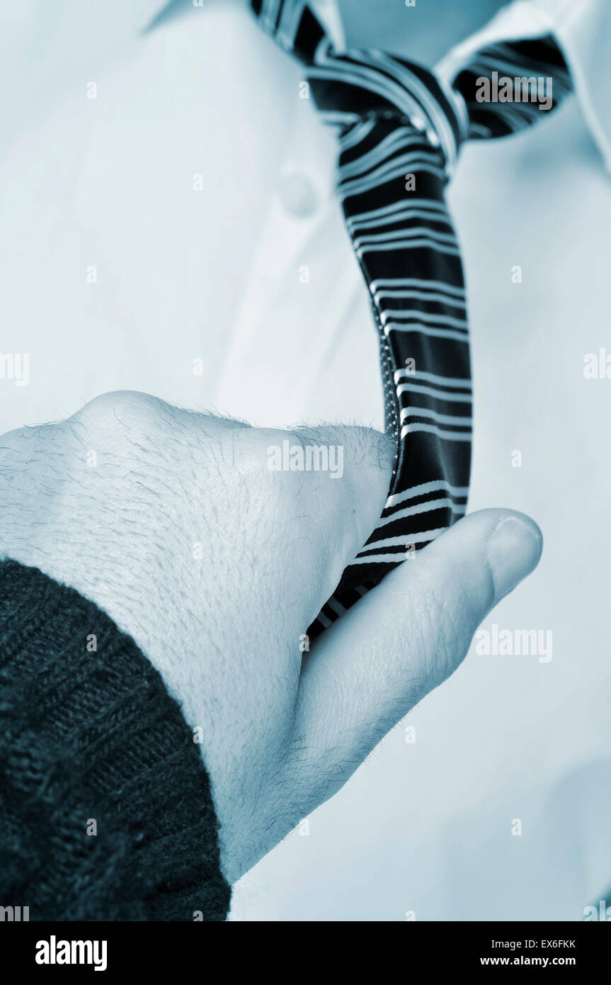 a man loosening the tie of another man Stock Photo - Alamy