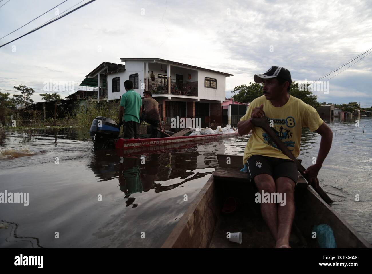 Apure, Venezuela. 7th July, 2015. People move in boats in a flooded street in the town of Guasdualito, Apure state, Venezuela, on July 7, 2015. According to local press, more than 9,000 families were affected by the floods caused by the overflowing of the rivers Arauca and Sarare. Credit:  Str/Xinhua/Alamy Live News Stock Photo
