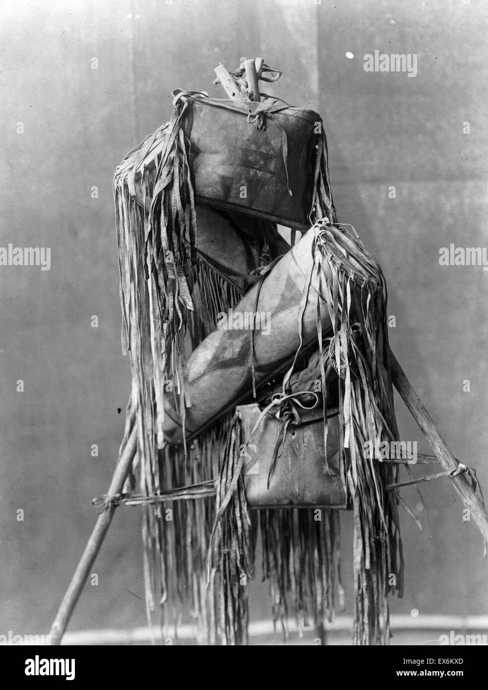 Four Native American Piegan fringed leather Medicine bags hung on tripod. By Edward Curtis 1868-1952, photographer 1910 Stock Photo