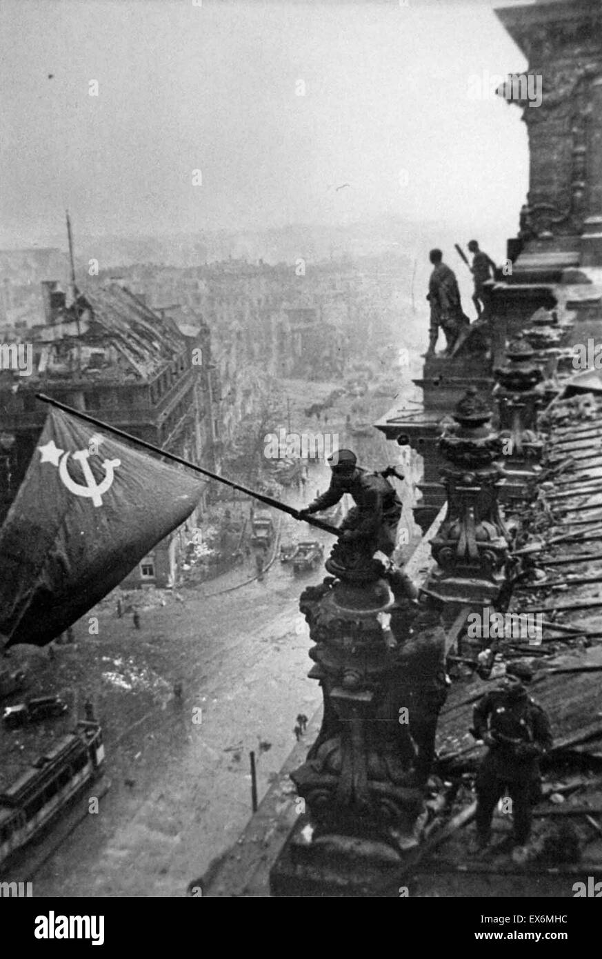 Russian flag is flown over the ruins of the Reichstag, in Berlin at the end of world war two. (photo by Yevgeny Khaldei, 1945) Stock Photo
