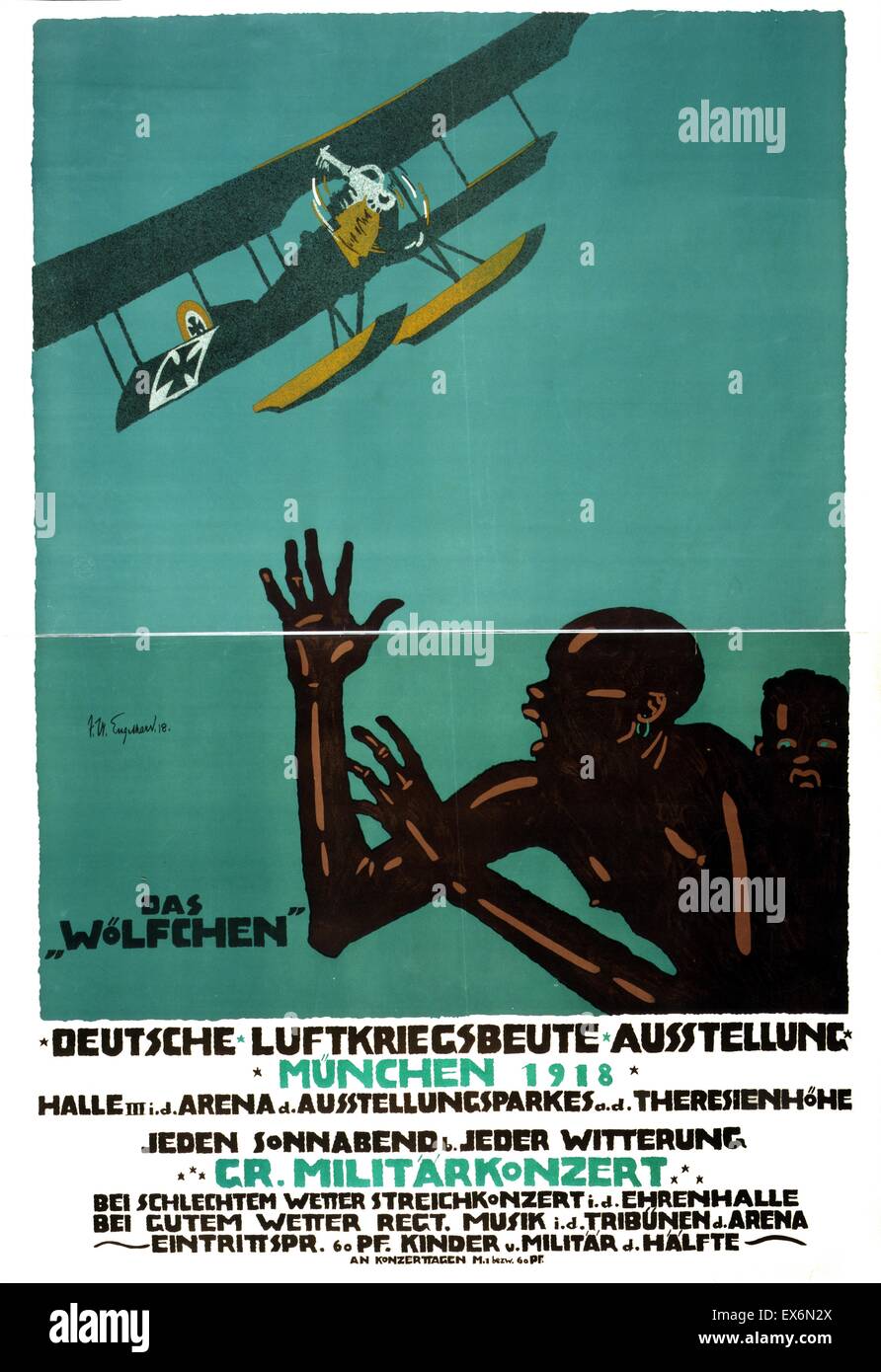 The poster depicts a German land/sea biplane, the 'Wolfschen', flying over Africans who are cowering in fear. The text provides information about an exhibition in Munich of captured war items. Dated 1918 Stock Photo