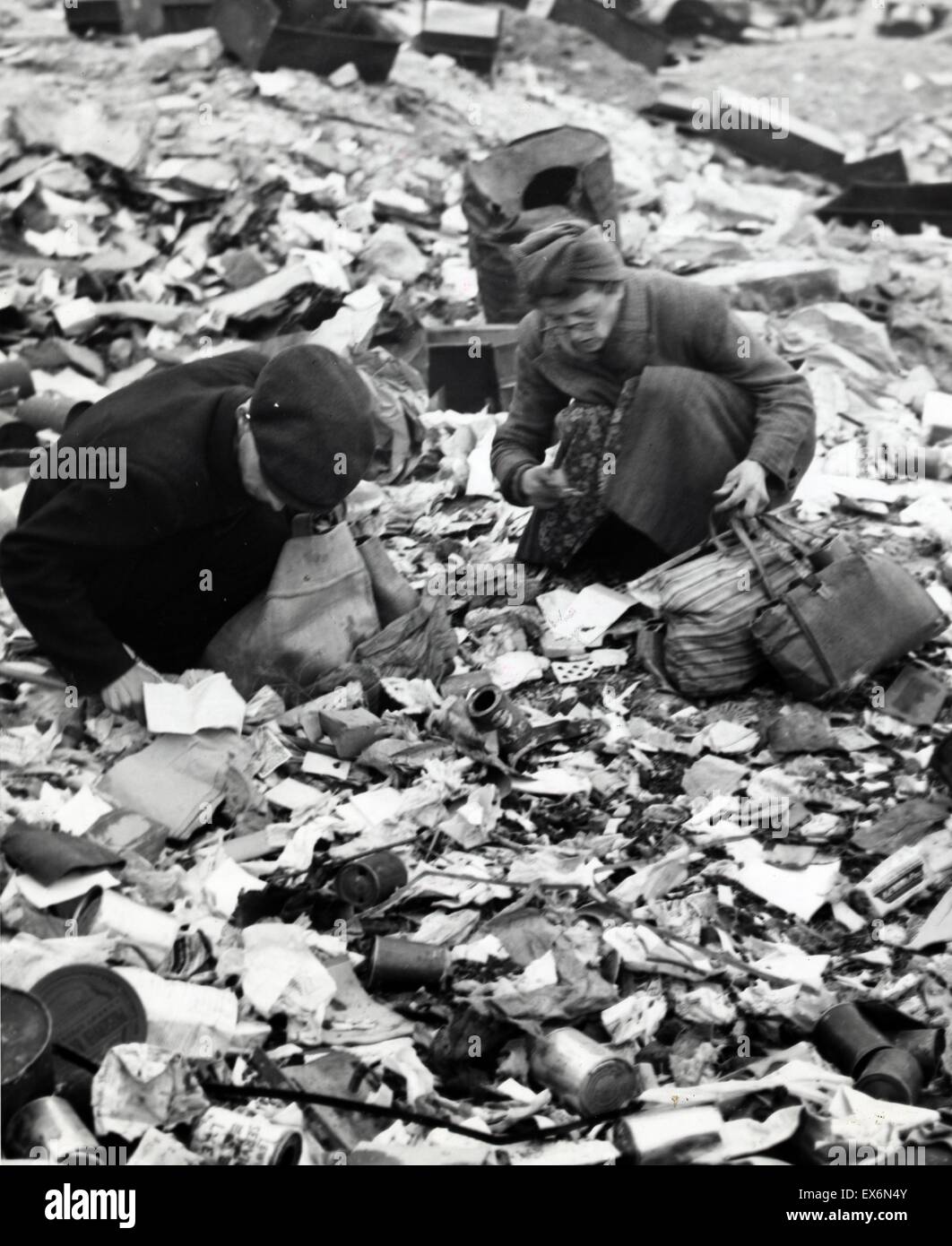 Photograph depicting a starving Berliners searching for food in a garbage dump during World War Two. Photographed by Emil Reynolds. Dated 1945 Stock Photo