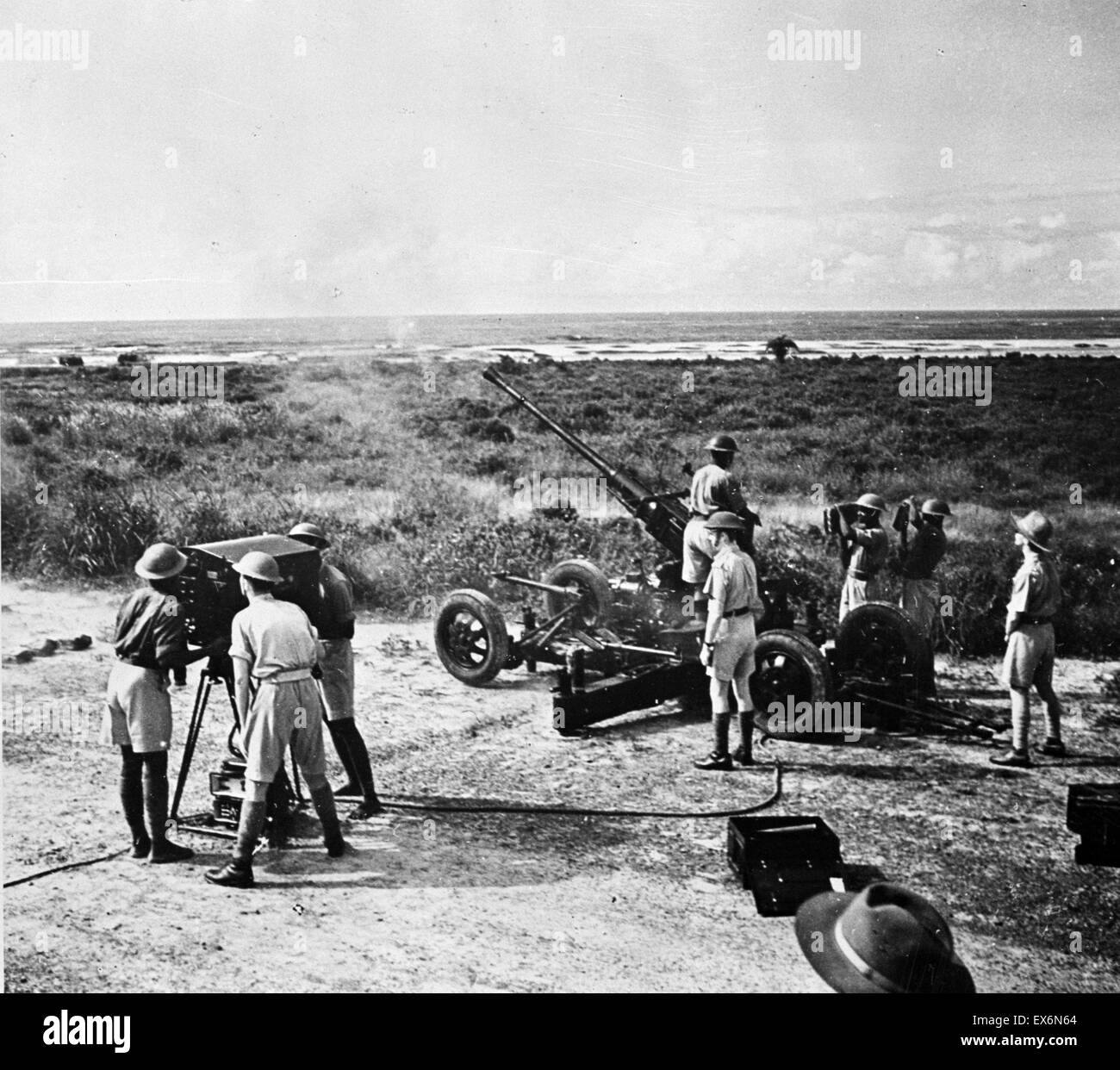 Photographic print of Bofors gun firing during target practice. This Gold Coast Battery has a mixed British and African gun crew. Dated 1945 Stock Photo
