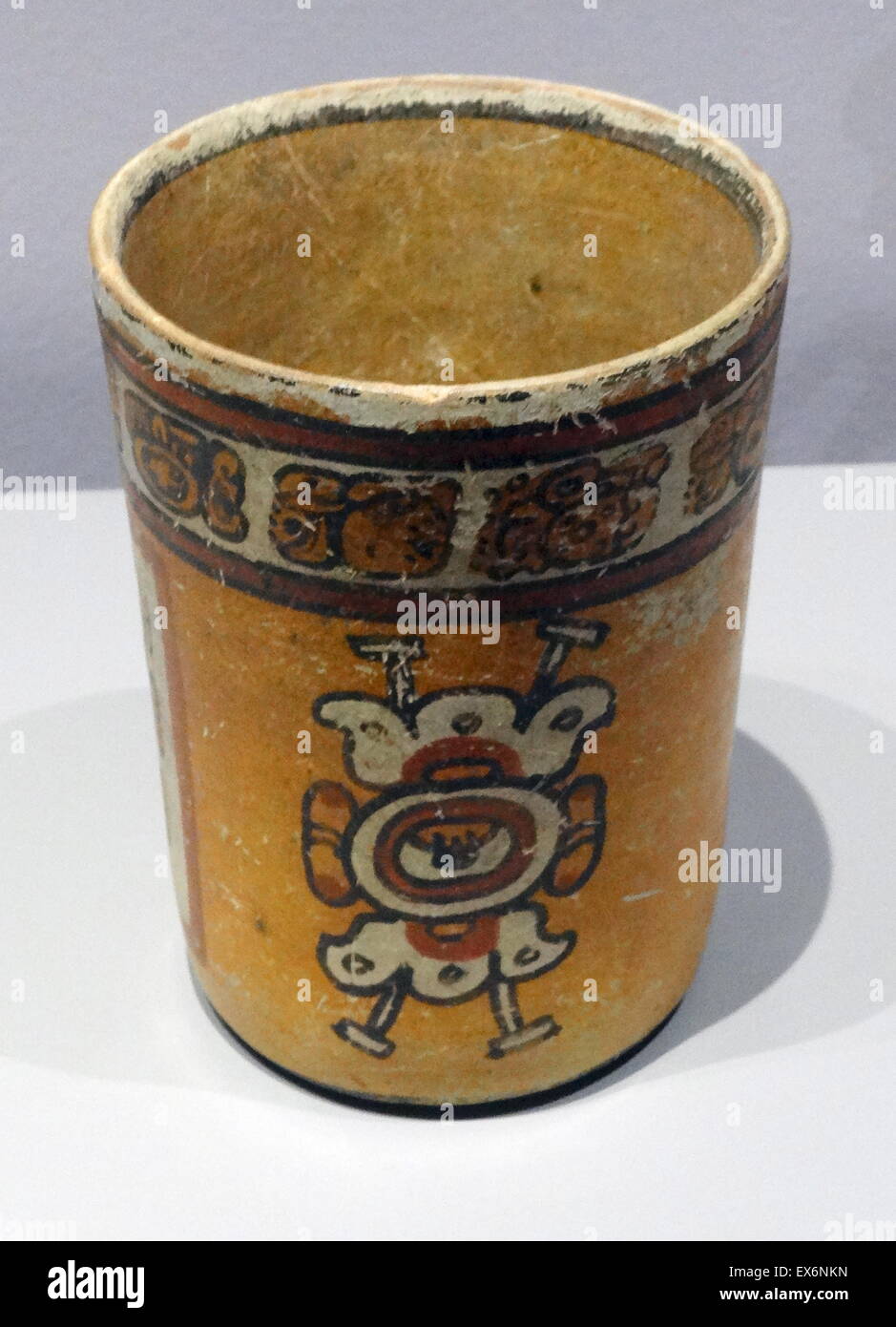 Polychrome vase decorated with flowers. The white flowers that adorn the vase are related to the supernatural world. The container belonged to a noble lineage and was originally intended to be used for drinking cocoa - something that the band of glyphs ar Stock Photo