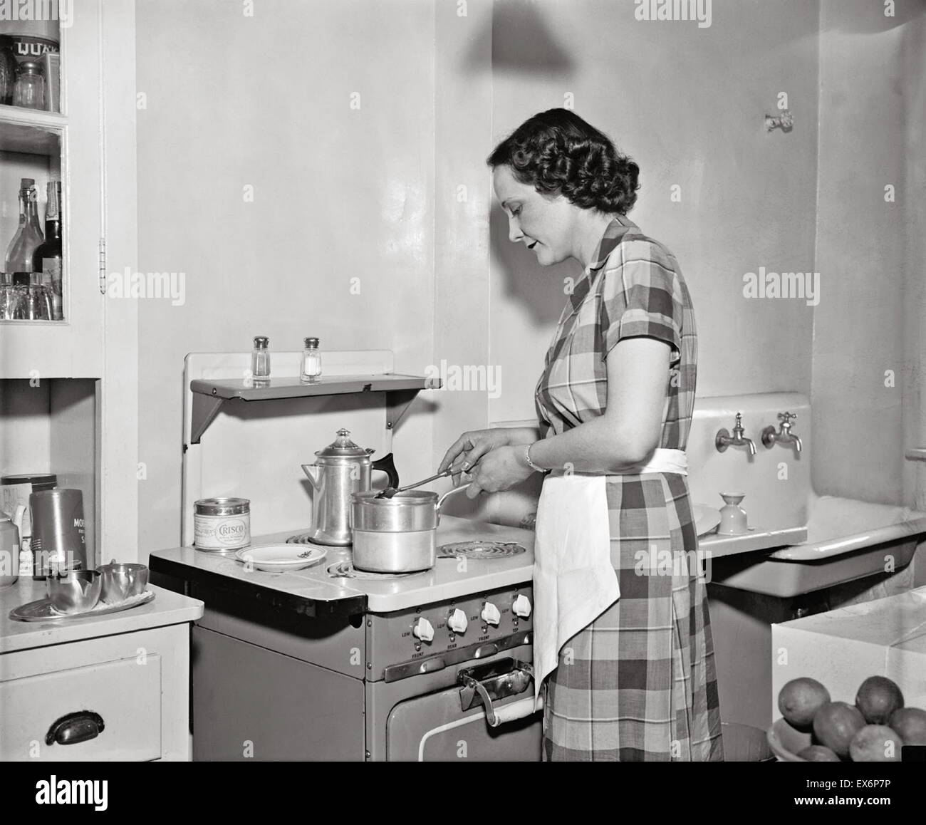 Mrs. Claude Pepper, wife of the Democratic Senator from Florida, at her oven in the kitchen of their home. 1937 Stock Photo