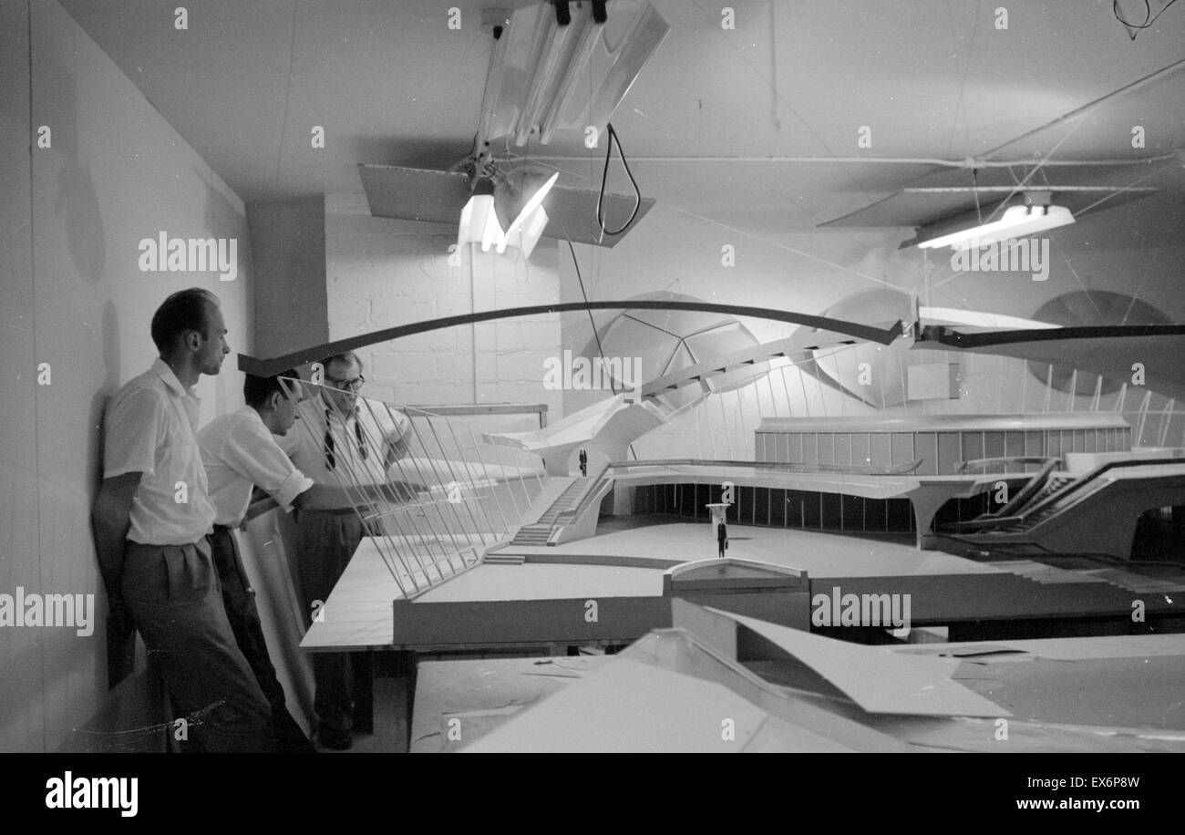 architect Eero Saarinen, 1910-1961, studies a scale model of the Trans World Airlines Terminal, John F. Kennedy (originally Idlewild) Airport, New York, New York, 1956-62. Stock Photo