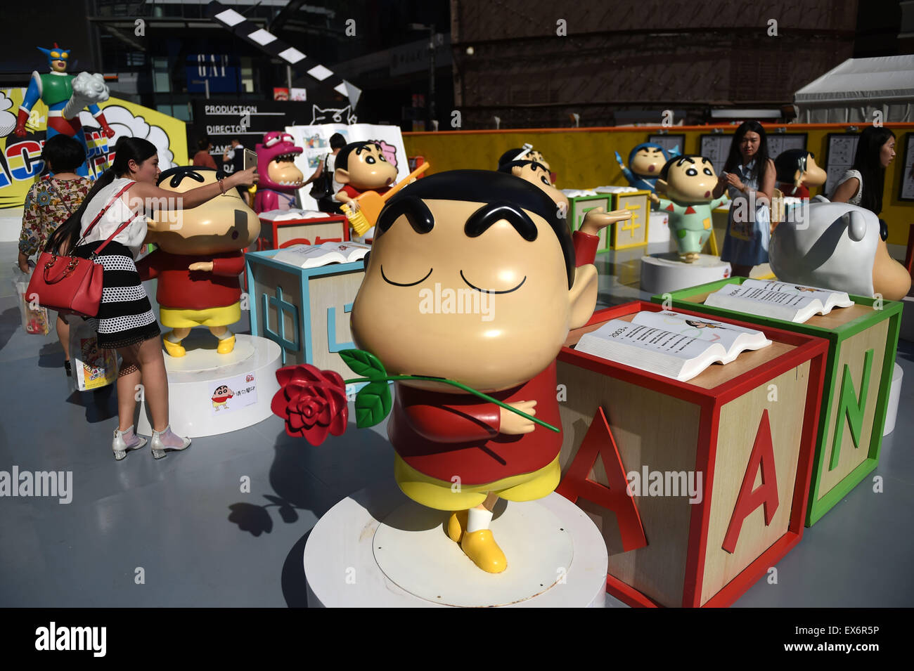 Shenyang, China's Liaoning Province. 8th July, 2015. People visit the exhibition marking the 25th anniversary of Japanese manga series Crayon Shin-chan in Shenyang, northeast China's Liaoning Province, July 8, 2015. The exhibition will be open to public on July 11. © Pan Yulong/Xinhua/Alamy Live News Stock Photo