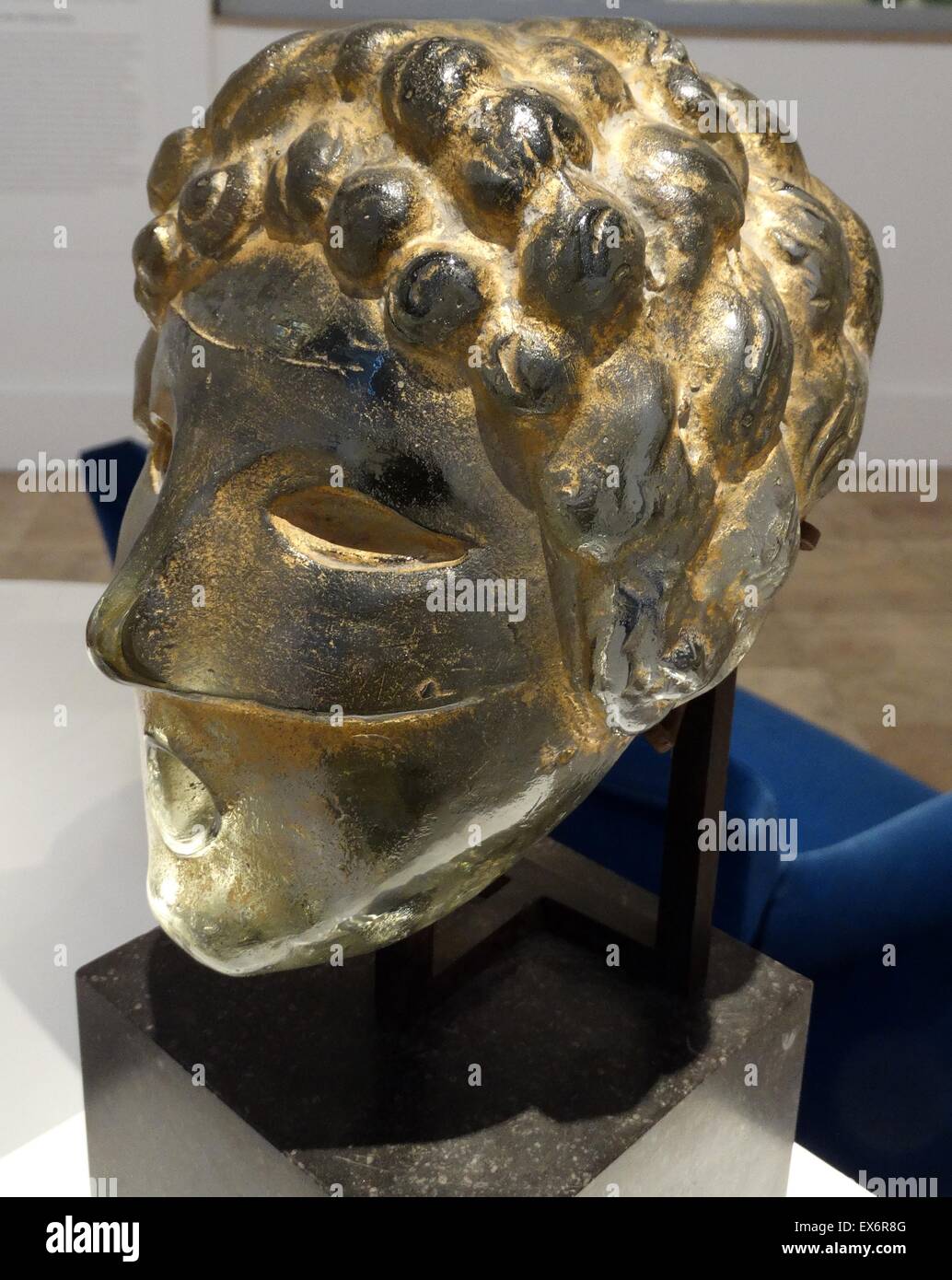 Gold painted glass wall fountain mask by Henri Edouard Navarre (1885-1971) French artist who primarily works with glass. Dated 1937 Stock Photo