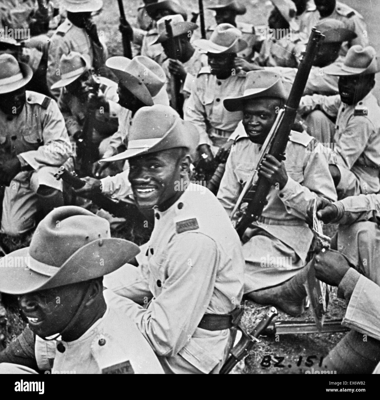 Ashanti troops in Gold Coast Regiment. Smartness in the parade ground and cheerfulness under all conditions are traditional characteristics of the Royal West African Frontier Force. Ashanti troops serving in the Gold Coast Regiment are shown resting by ro Stock Photo