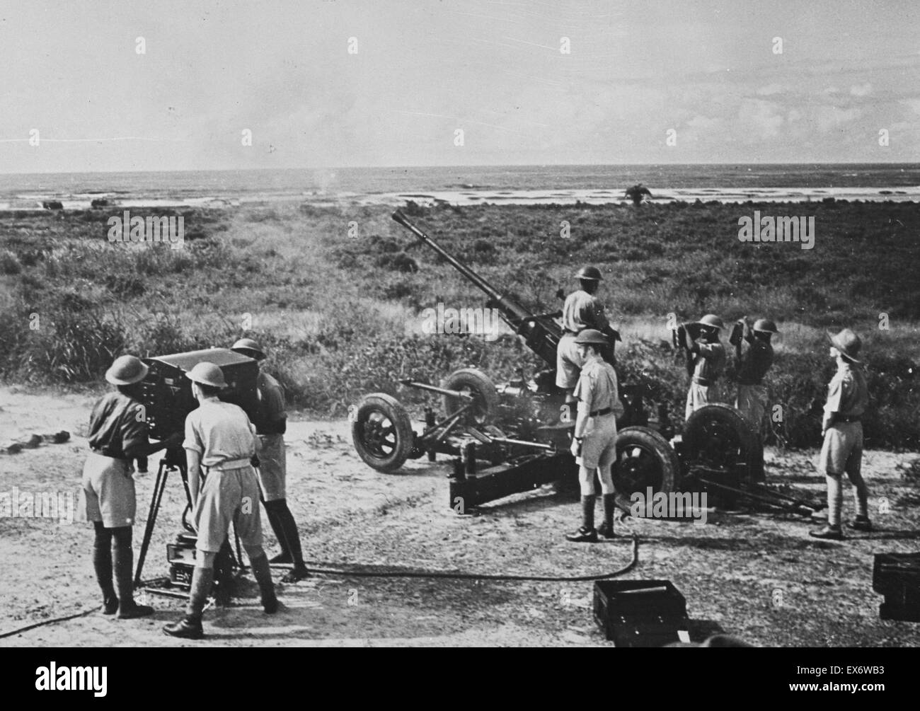 Gold Coast Battery in action. Boors gun firing at target during training. This Gold Coast Battery has a mixed British and African gun crew. between 1940 & 1946. Stock Photo