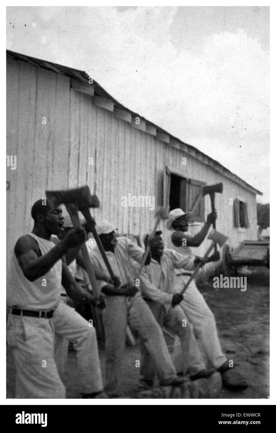 Photographic print of African American convicts singing in the woodyard, Darrington State Farm, Texas. Photographed by Alan Lomax (1915-2002). Dated 1934 Stock Photo