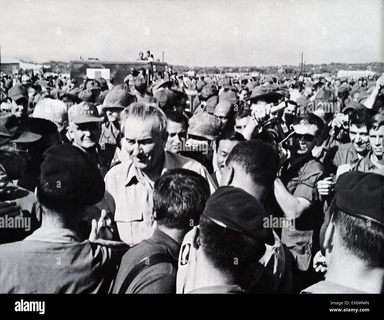 President Lyndon B. Johnson's brief visit to Cam Ranh Bay airbase in South Vietnam 1967 . Shows President Johnson addressing 7000 assembled troops, reviewing troops with USA General William C. Westmoreland and Air Vice Marshall Ky Stock Photo