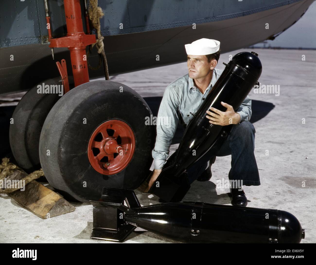 loading missiles on an aircraft at the Naval Air Base, Corpus Christi, Texas. 1942. Stock Photo