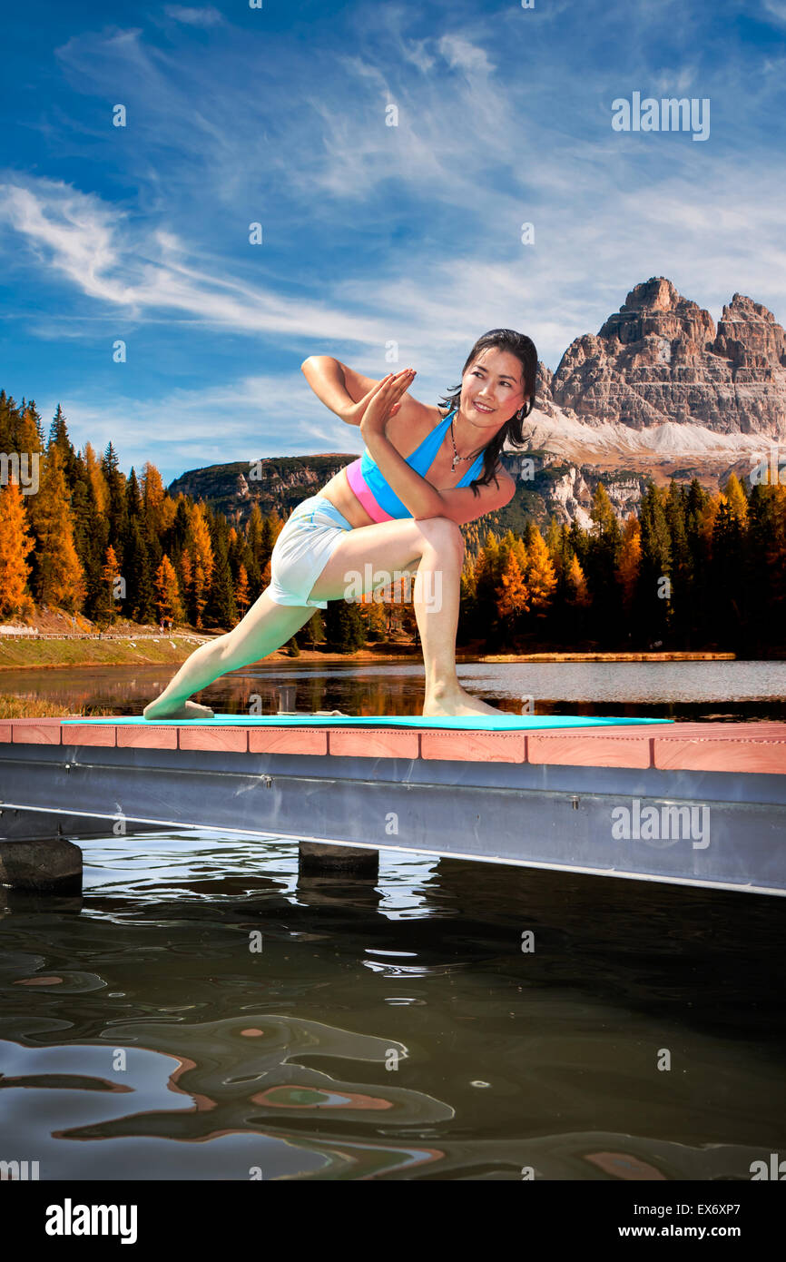 woman making yoga exercise at a lake Stock Photo - Alamy