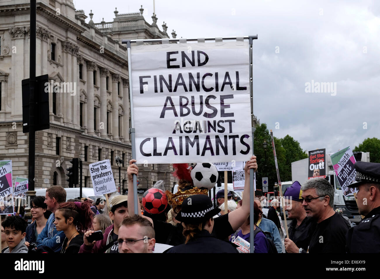 Protesters against welfare cuts hold a placard reading  " End financial abuse against claimants" Stock Photo