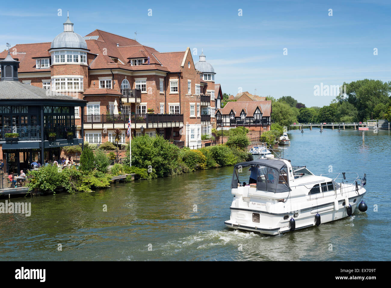 A pleasure cruiser on the river Thames at Windsor/Eton heads towards Romney lock. Stock Photo