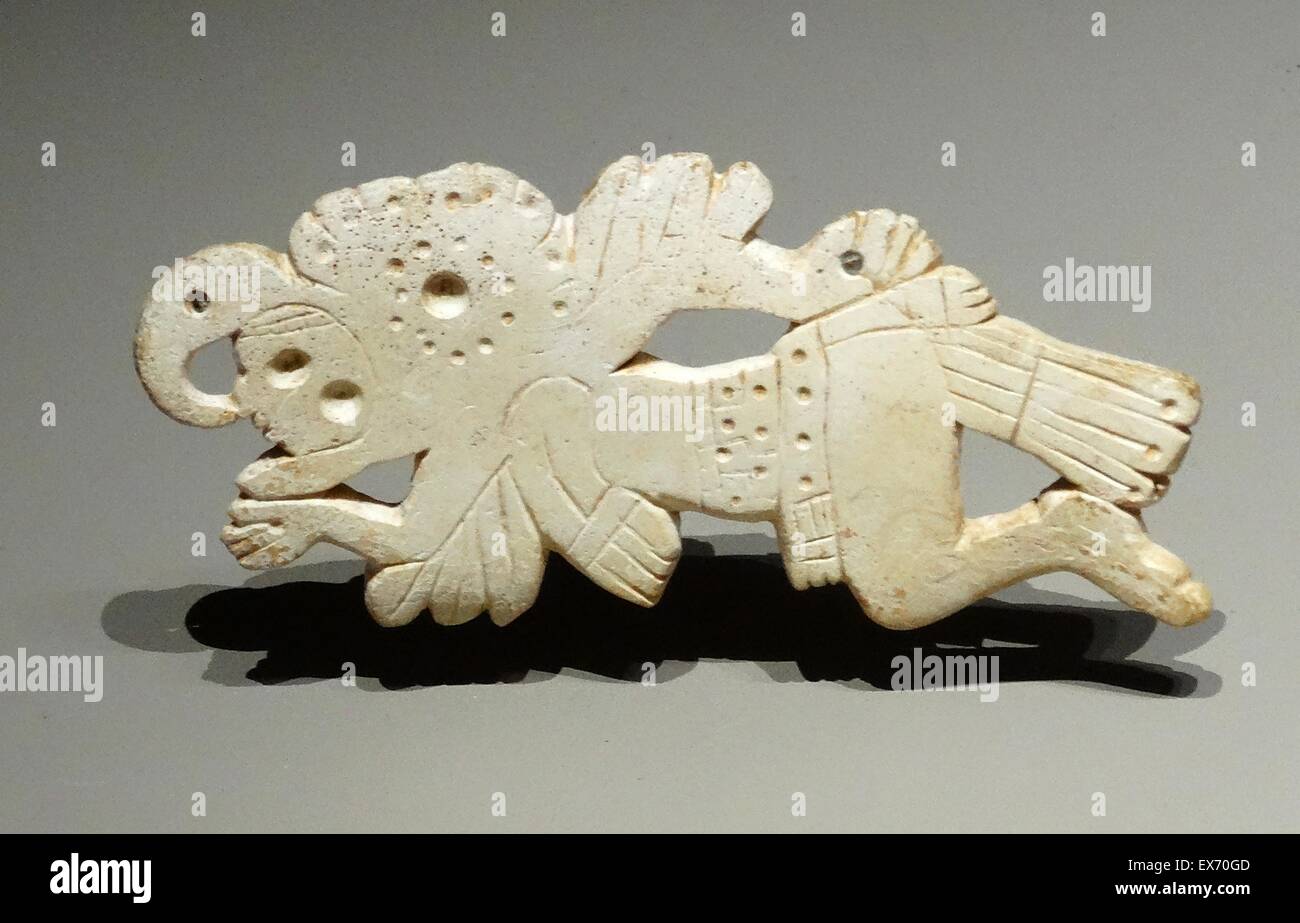 Mayan pendant decoration, depicting a man covered in feathers. It represents either the incarnation of a soldier or a bird priest, performing a ritual. 250-900 AD Mexico or Guatemala Stock Photo