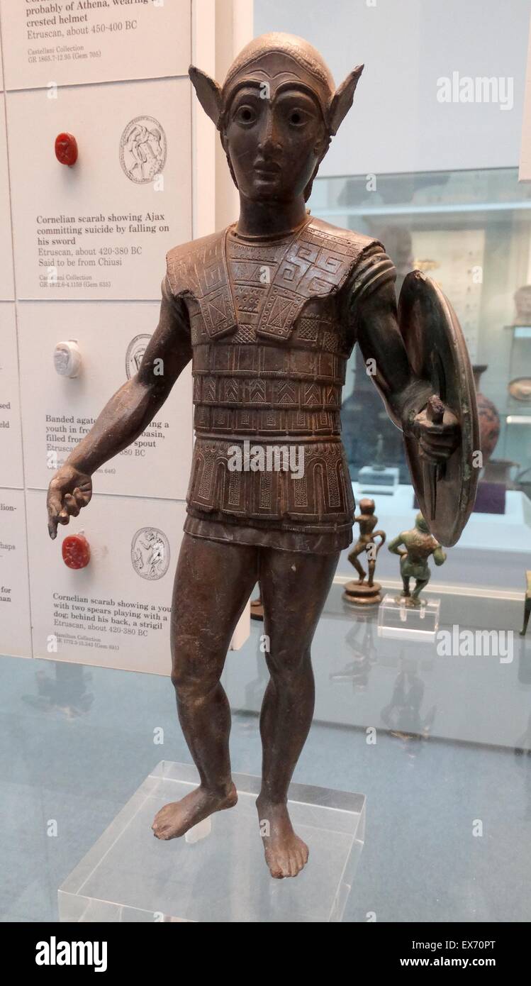 Etruscan, bronze votive statuette of a warrior with a shield, wearing an Attic helmet and a scale cuirass, about 420-400 BC From Mount Falterona. The style reflects Greek sculpture of the late 5th century BC, and the style is related to bronzes of central Stock Photo