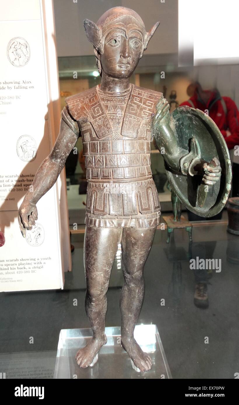 Etruscan, bronze votive statuette of a warrior with a shield, wearing an Attic helmet and a scale cuirass, about 420-400 BC From Mount Falterona. The style reflects Greek sculpture of the late 5th century BC, and the style is related to bronzes of central Stock Photo