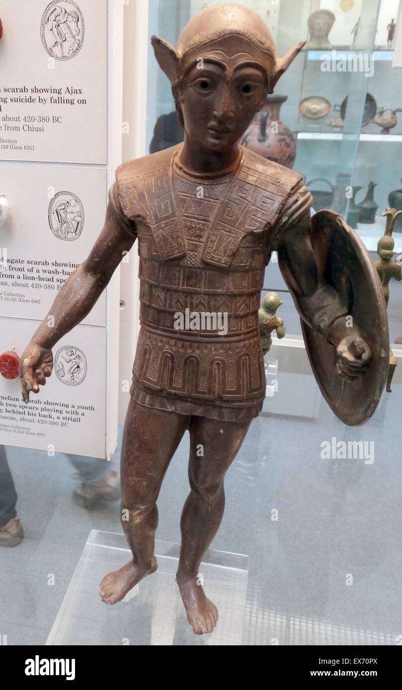 Etruscan, bronze votive statuette of a warrior with a shield, wearing an Attic helmet and a scale cuirass, about 420-400 BC From Mount Falterona. The style reflects Greek sculpture of the late 5th century BC, and the style is related to bronzes of central Stock Photo