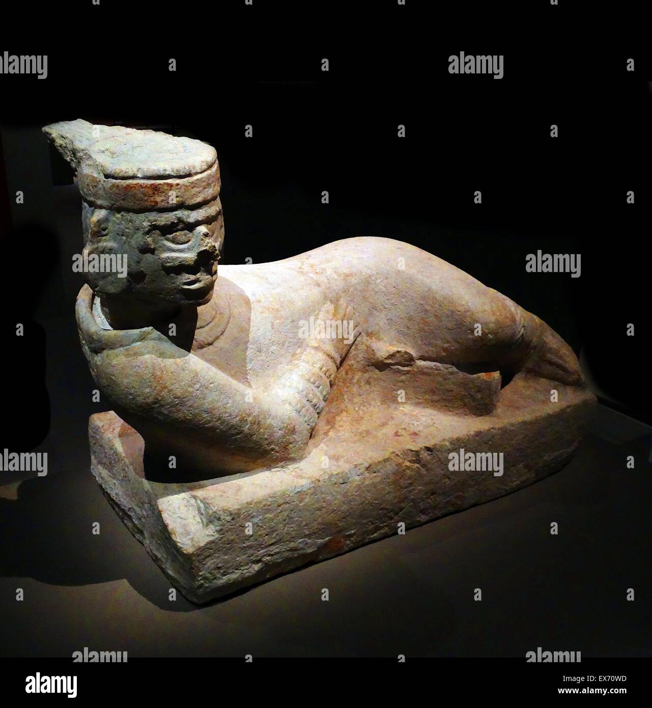 Chacmool (Chacmool) form of pre-Columbian, Mesoamerican sculpture, depicting a reclining figure with its head facing 90 degrees from the front, supporting itself on its elbows and supporting a bowl or a disk upon its stomach. These figures possibly symbol Stock Photo