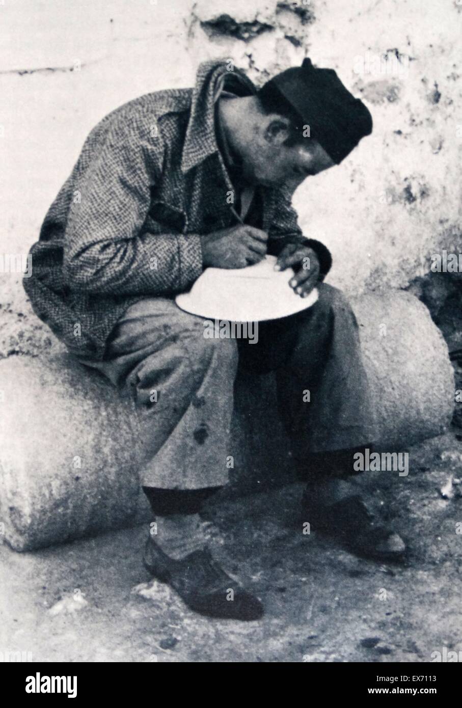 Republican soldier writes a note to his family while resting between battle action in the Spanish Civil War 1936 Stock Photo