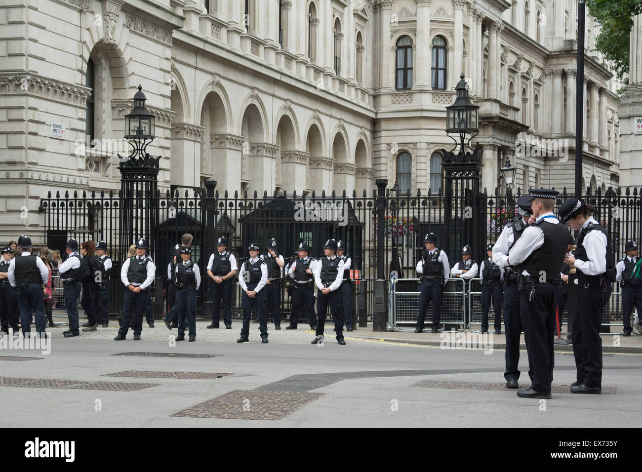 London, 08th July 2015. Police guard the entrance to Downing Street during a demonstration called 'Balls to the budget'. Anti-austerity and disability campaigners released multi-coloured balls into Whitehall outside Downing Street in protest at what they see as a budget which persecutes and demonises benefit claimants, then marched past Parliament and blocked Westminster Bridge Credit:  Patricia Phillips/Alamy Live News Stock Photo