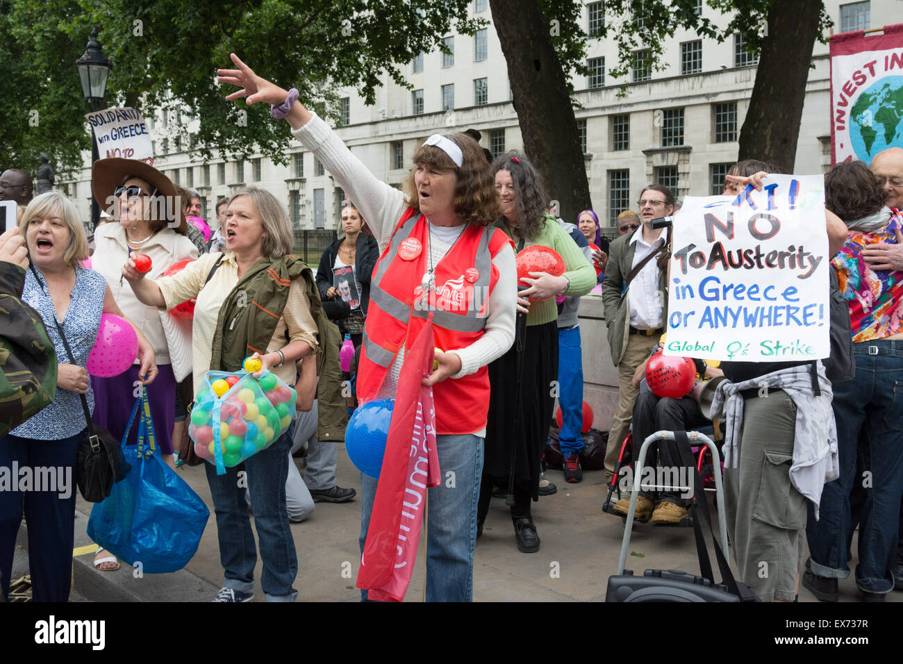 London, 08th July 2015. Protesters against Chancellor George Osbourne's budget come together in a demonstration they call 'Balls to the budget'. Anti-austerity and disability campaigners released multi-coloured balls into Whitehall outside Downing Street in protest at what they see as a budget which persecutes and demonises benefit claimants, then marched past Parliament and blocked Westminster Bridge Credit:  Patricia Phillips/Alamy Live News Stock Photo