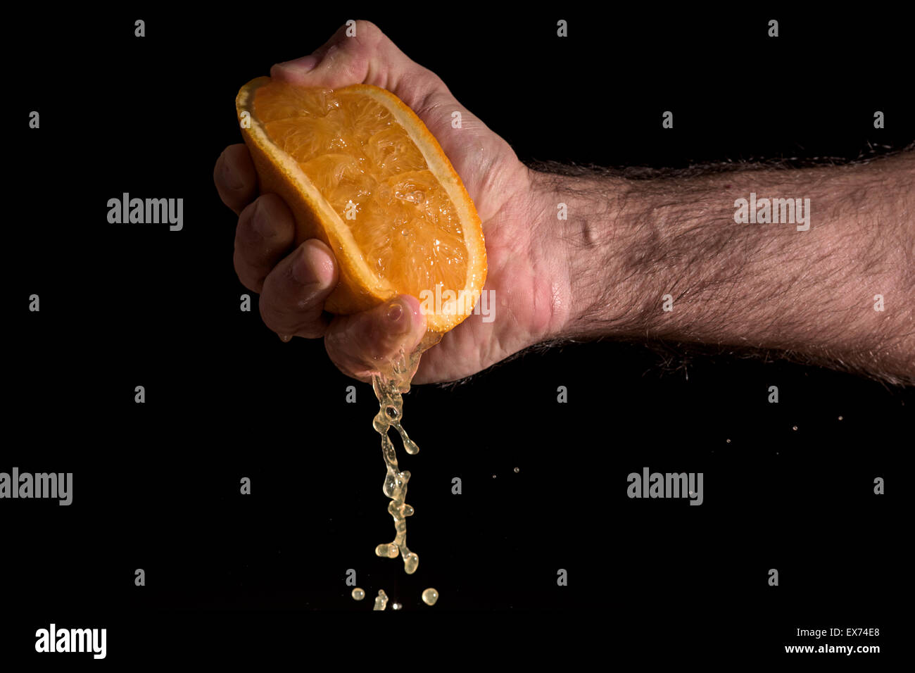 Hand squeezing orange hires stock photography and images Alamy