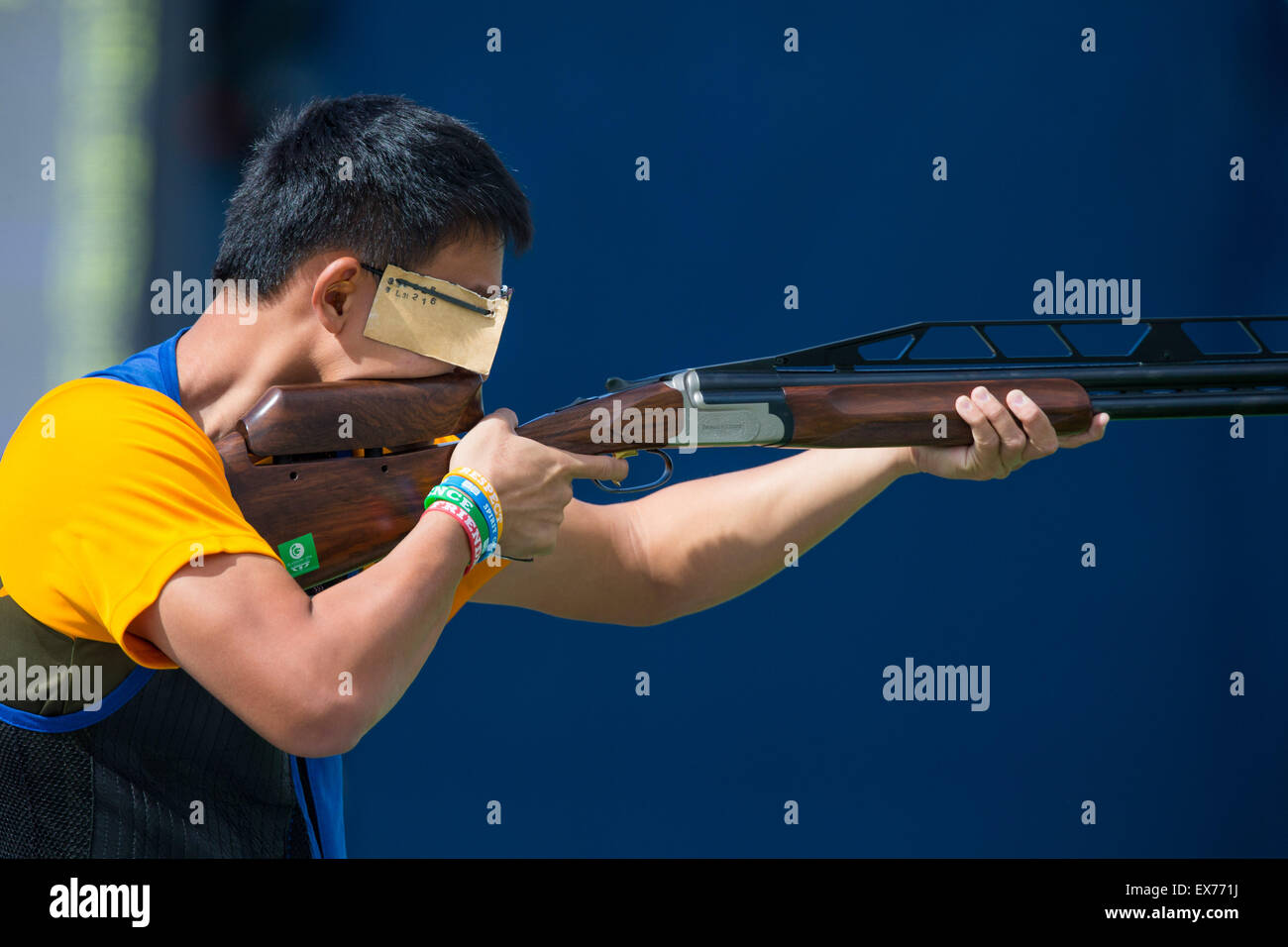 Malaysia's Benjamin Khor competing at the Barry Buddon Shooting Centre during the Glasgow Commonwealth Games on July 27, 2014. Stock Photo