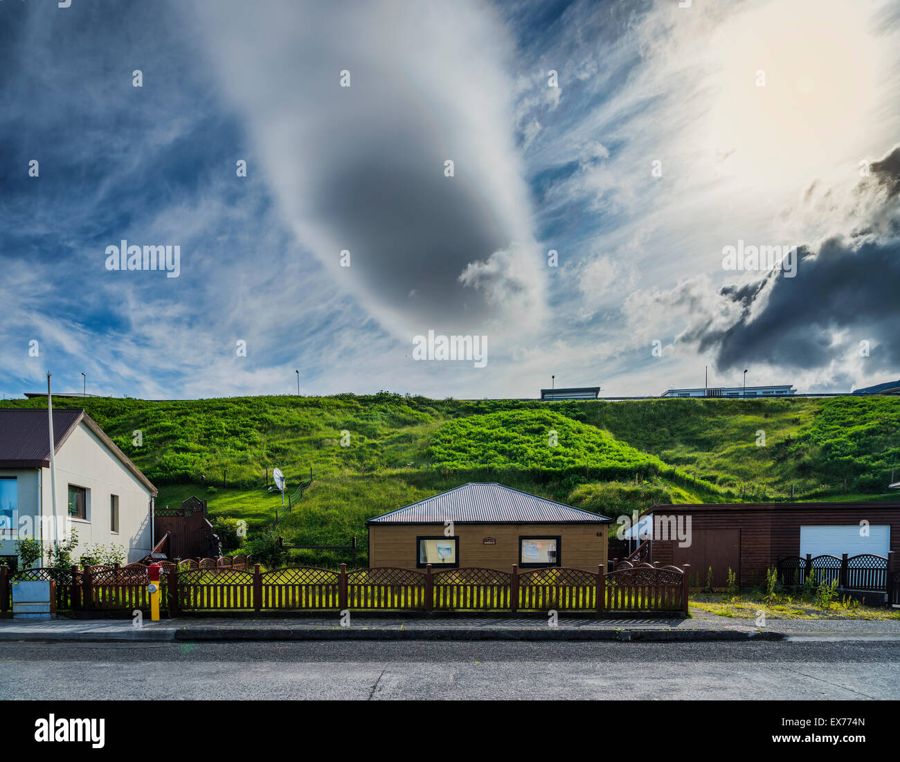 Clouds over a quiet street in a small village, Olafsvik, Snaefellnes Peninsula, Iceland Stock Photo