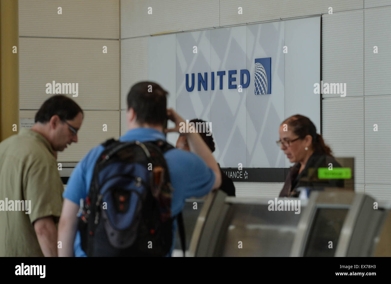 Washington, DC, USA. 8th July, 2015. People check in baggages with United Airlines at Ronald Reagan Washington National Airport in Washington, DC, the United States, on July 8, 2015. United Airlines (UA) resumed flights at all airports that had been grounded Wednesday morning for about two hours due to a computer glitch, according to the U.S. Federal Aviation Administration (FAA). Credit:  Bao Dandan/Xinhua/Alamy Live News Stock Photo