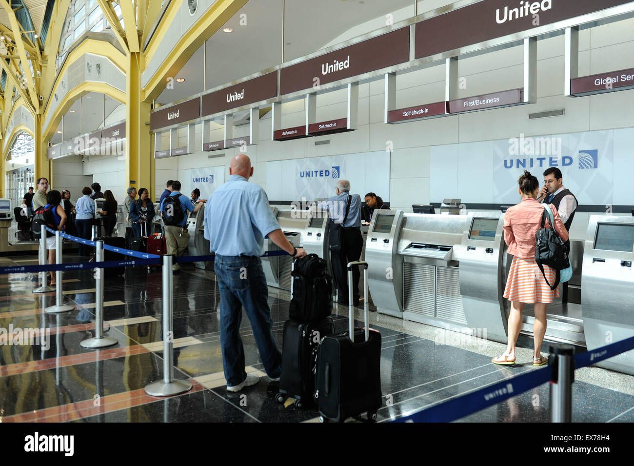 Washington, DC, USA. 8th July, 2015. People check in baggages with United Airlines at Ronald Reagan Washington National Airport in Washington, DC, the United States, on July 8, 2015. United Airlines (UA) resumed flights at all airports that had been grounded Wednesday morning for about two hours due to a computer glitch, according to the U.S. Federal Aviation Administration (FAA). Credit:  Bao Dandan/Xinhua/Alamy Live News Stock Photo