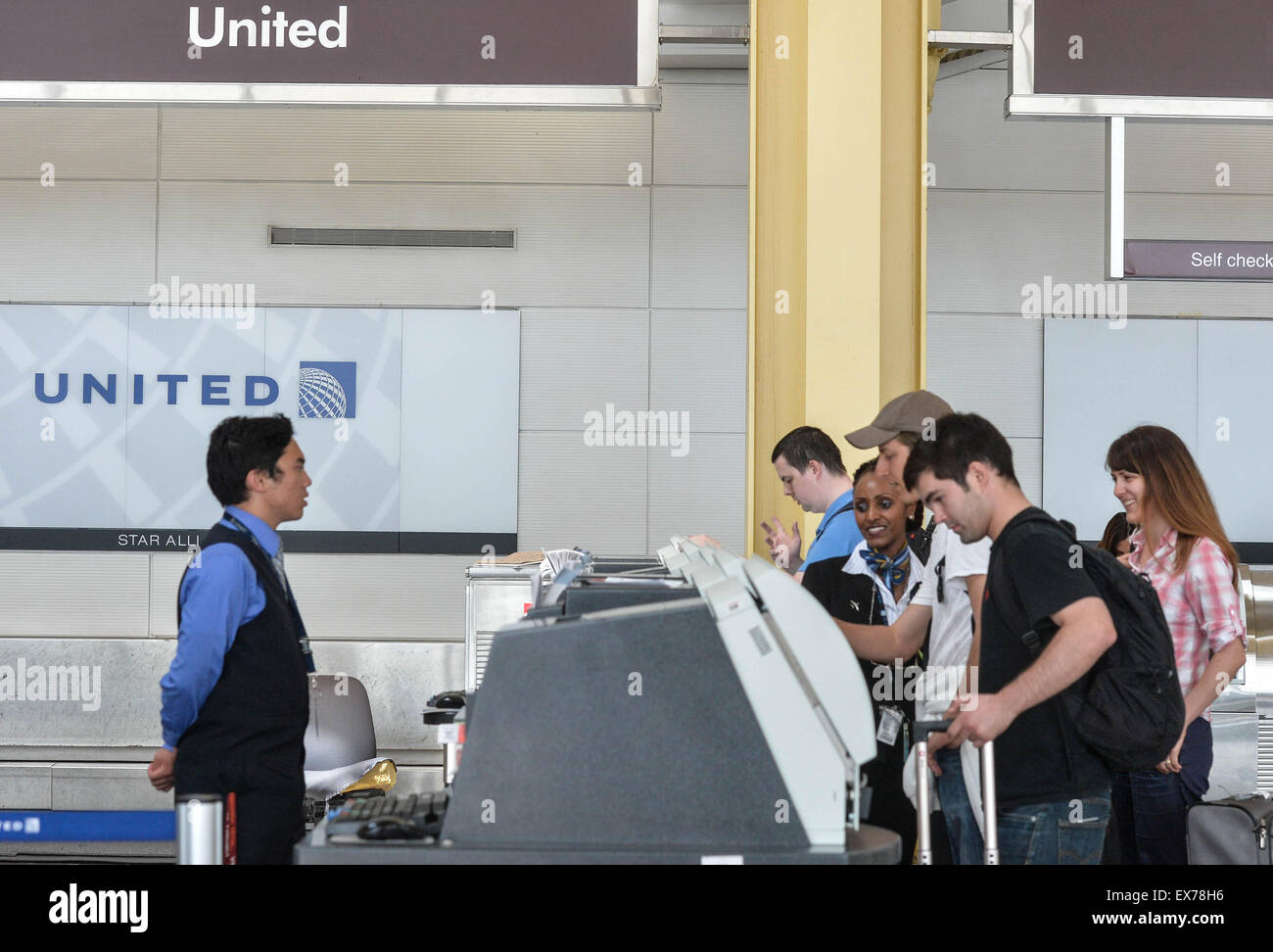 Washington, DC, USA. 8th July, 2015. Passengers print boarding cards with United Airlines at Ronald Reagan Washington National Airport in Washington, DC, the United States, on July 8, 2015. United Airlines (UA) resumed flights at all airports that had been grounded Wednesday morning for about two hours due to a computer glitch, according to the U.S. Federal Aviation Administration (FAA). Credit:  Bao Dandan/Xinhua/Alamy Live News Stock Photo