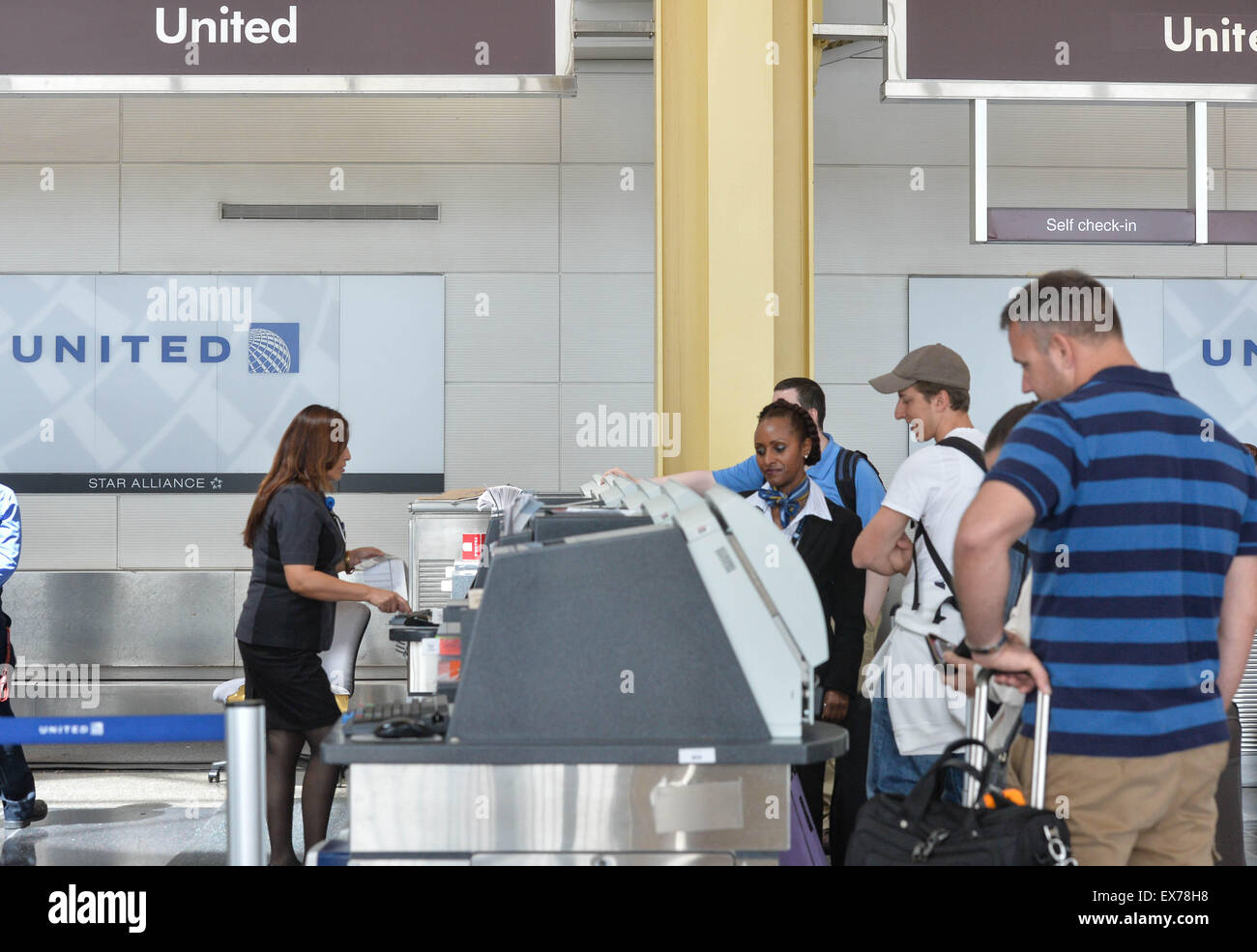 Washington, DC, USA. 8th July, 2015. People print boarding cards with United Airlines at Ronald Reagan Washington National Airport in Washington, DC, the United States, on July 8, 2015. United Airlines (UA) resumed flights at all airports that had been grounded Wednesday morning for about two hours due to a computer glitch, according to the U.S. Federal Aviation Administration (FAA). Credit:  Bao Dandan/Xinhua/Alamy Live News Stock Photo