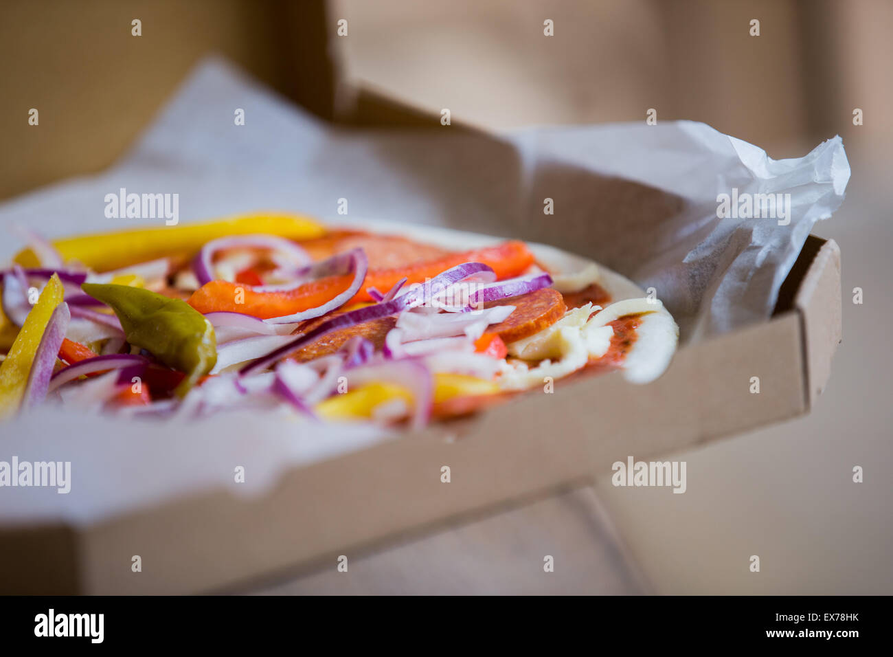 Bonn, Germany. 7th July, 2015. A raw pizza is put into the oven at the Vapiano headquaters in Bonn, Germany, 7 July 2015. The restaurant chain hopes in the future to deliver 'Homebaked Pizza' - pizza that the customer bakes in the oven themselves. Photo: Rolf Vennenbernd/dpa/Alamy Live News Stock Photo