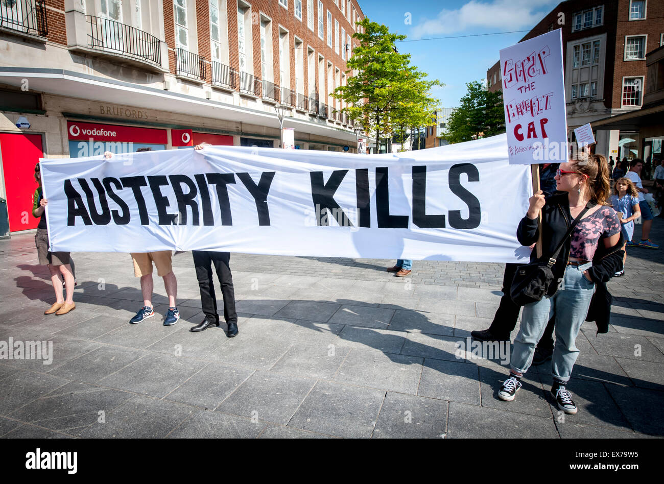 Exeter, Devon, UK. 8th July, 2015. The Austerity Kills banner is held up during the Exeter Budget Day Action #AusterityKills in Exeter City Centre on july 8th, 2015 in Bedford Square, Exeter, UK Credit:  Clive Chilvers/Alamy Live News Stock Photo