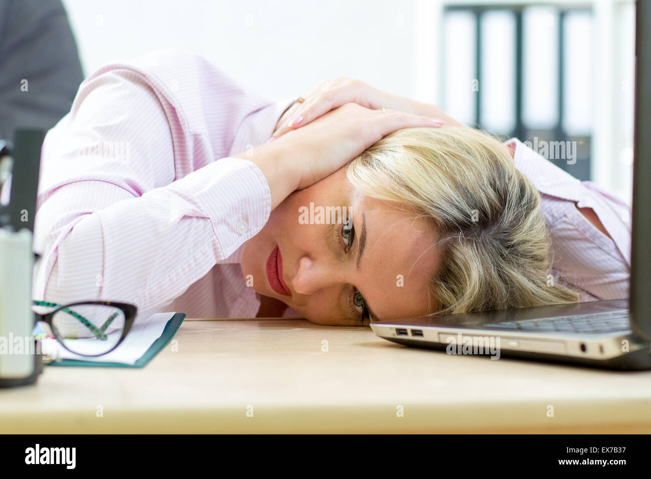 Tired middle-aged businesswoman in her office Stock Photo