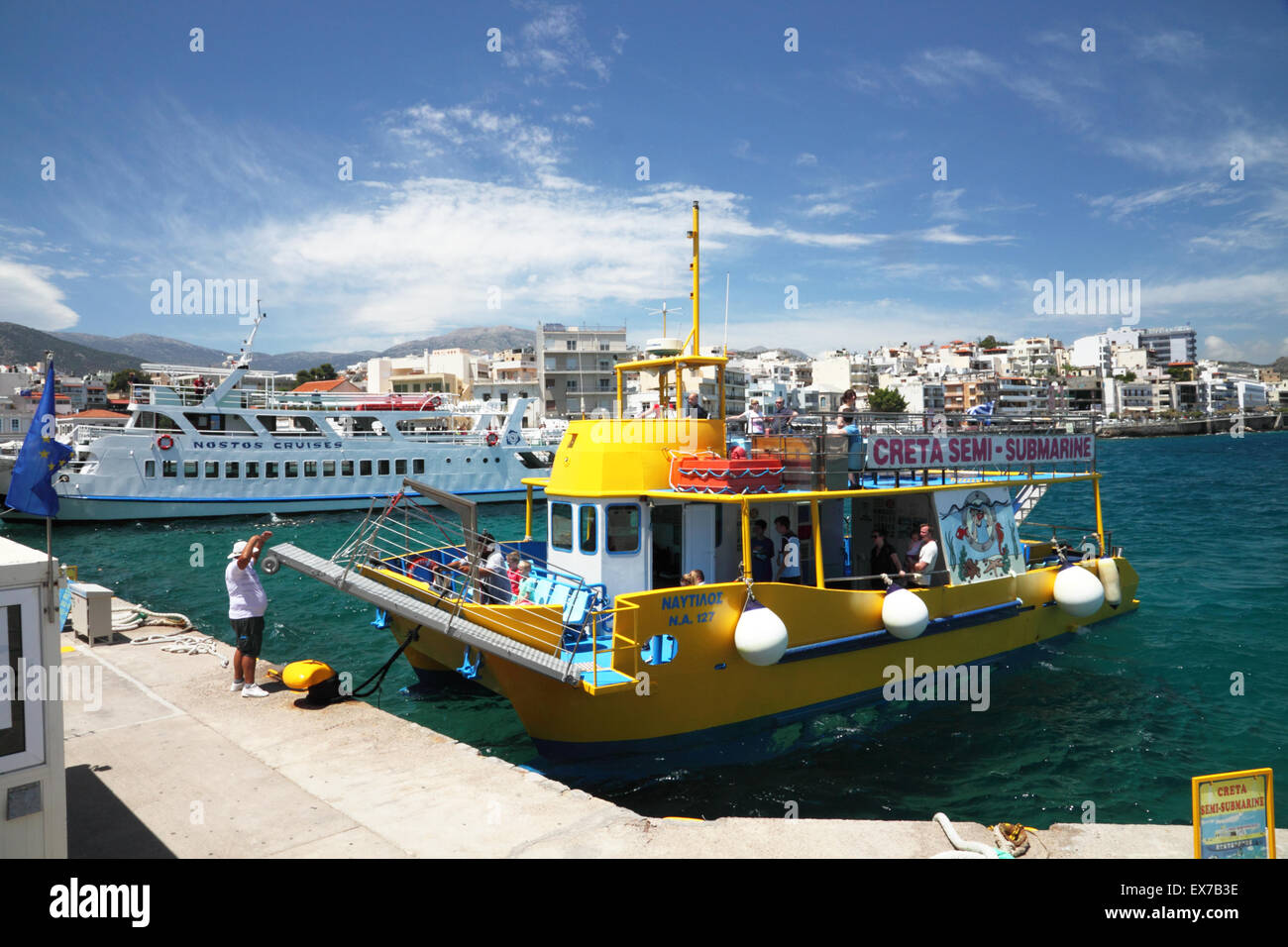 A yellow boat moored in a Mediterranean harbour Stock Photo - Alamy