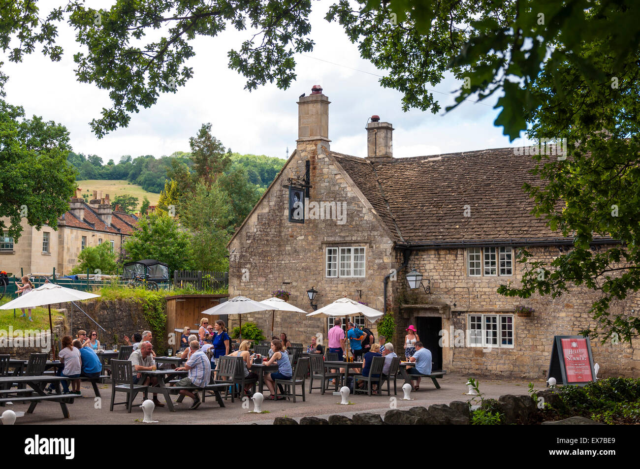 People enjoying a drink outside The George pub in Bathampton, Bath, Somerset, UK Stock Photo